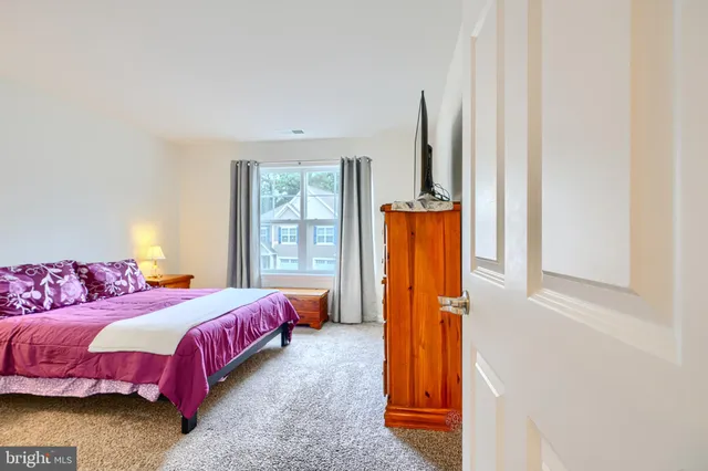 a view of a livingroom with furniture and a large window