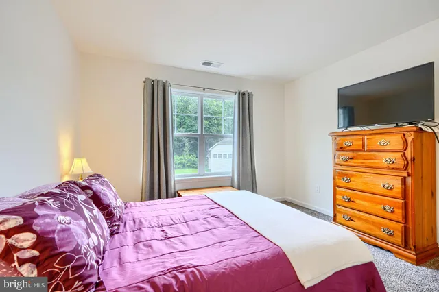 a view of a house with a window and yard in back yard