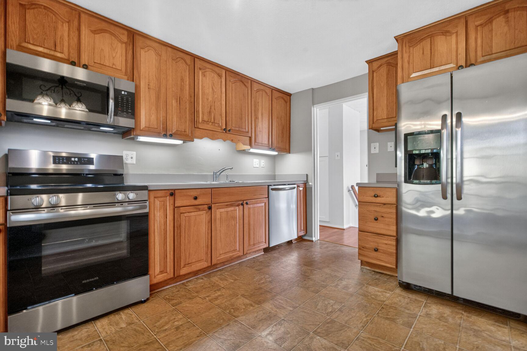 2806 Logway Road Vienna, VA 22181 - Photo 7 of 33 a kitchen with stainless steel appliances granite countertop a stove a refrigerator and a microwave