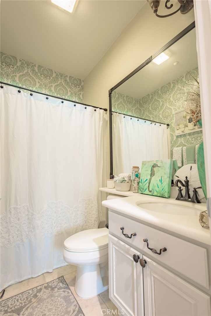 1045 Inverlochy Drive Fallbrook, CA 92028 - Photo 9 of 39 a bathroom with a sink a toilet and a mirror