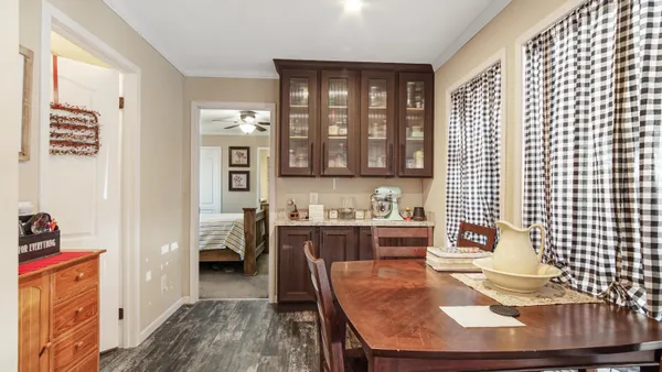 a dining room with stainless steel appliances kitchen island granite countertop a refrigerator a stove a sink and dishwasher