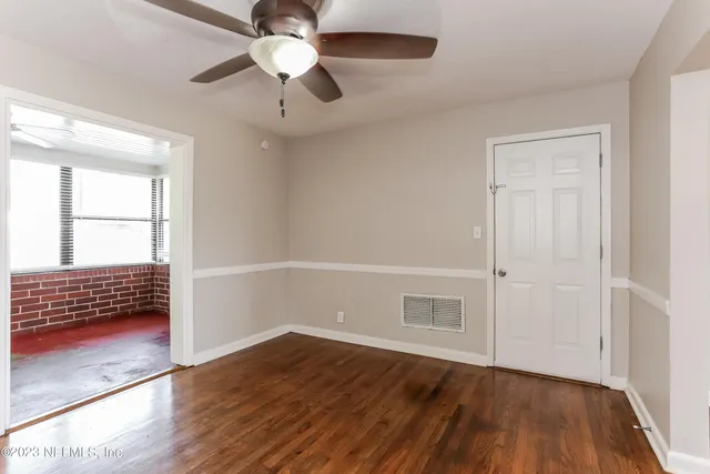 wooden floor in an empty room with a window