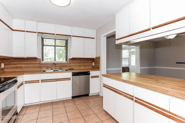a kitchen with stainless steel appliances granite countertop a sink and a stove