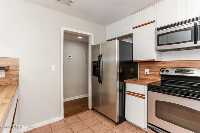 a kitchen with a refrigerator stove and microwave
