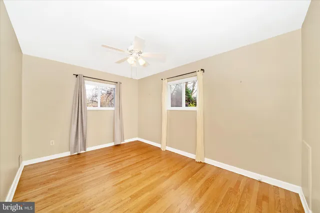 a view of empty room with wooden floor