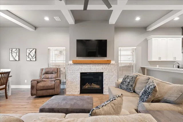 a living room with furniture a fireplace and a flat screen tv