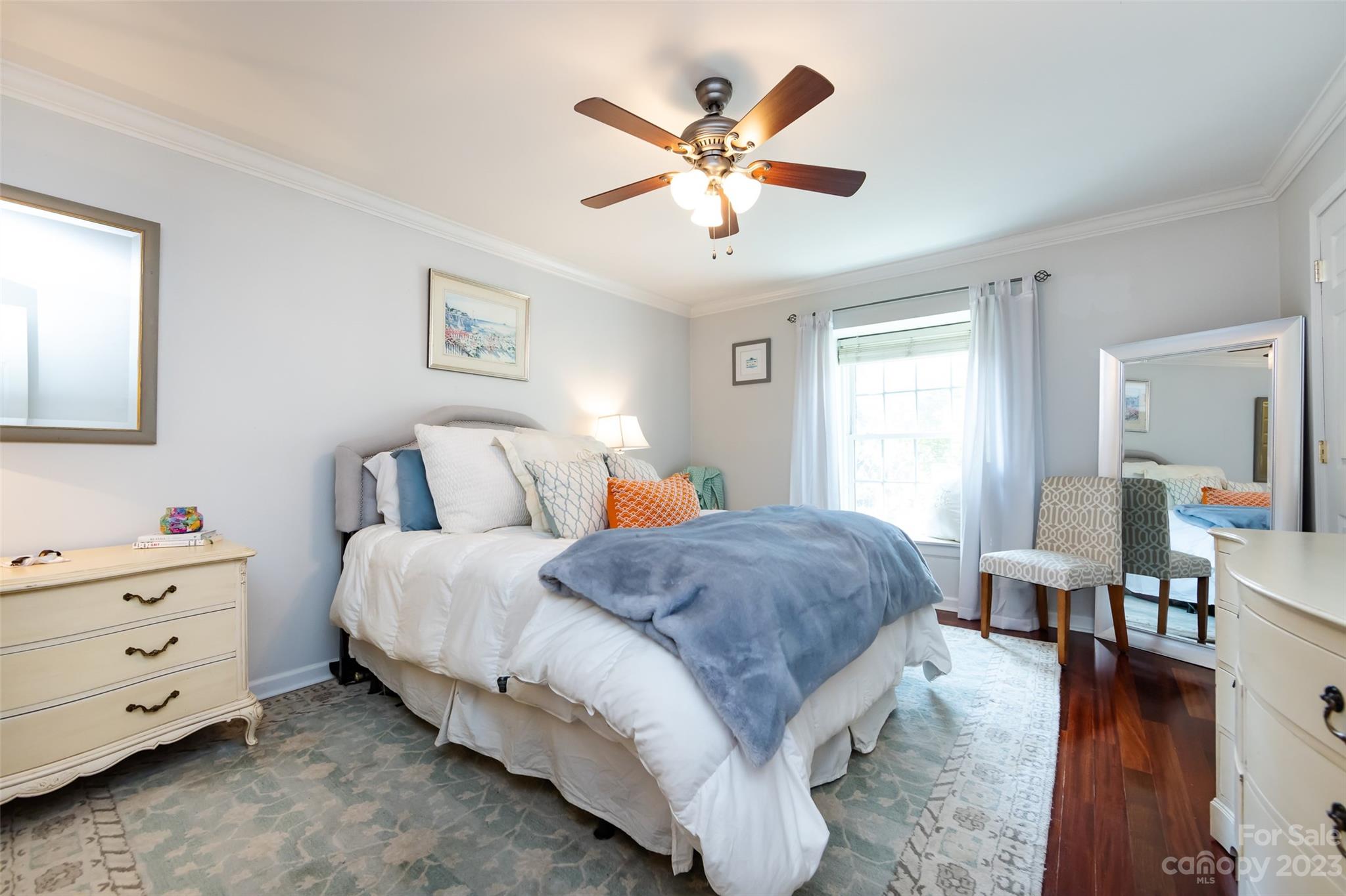 3520 Colony Road, Unit C Charlotte, NC 28211 - Photo 17 of 25 a spacious bedroom with a bed and a chandelier