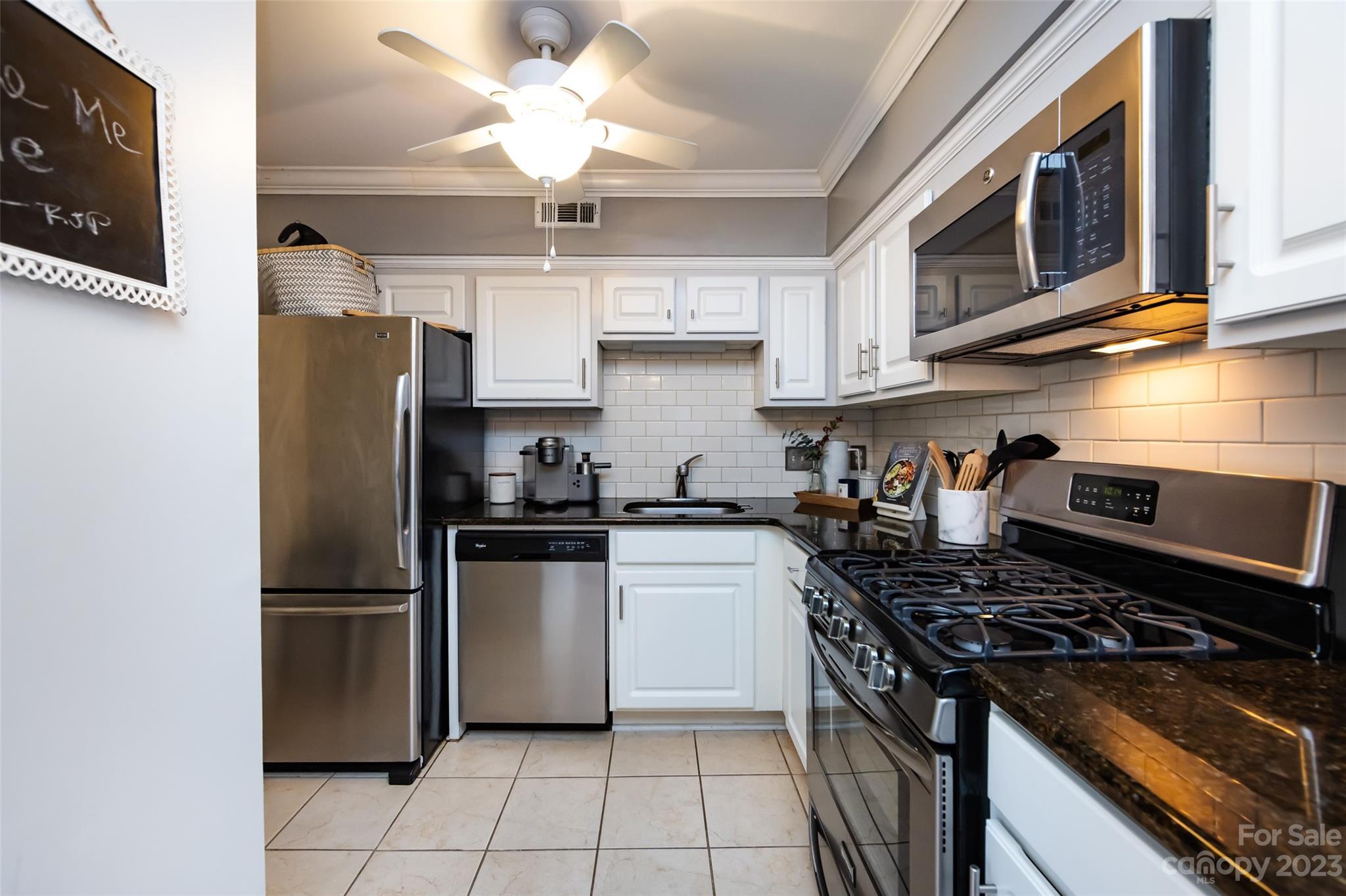 3520 Colony Road, Unit C Charlotte, NC 28211 - Photo 8 of 25 a kitchen with stainless steel appliances granite countertop a stove top oven a refrigerator a sink and dishwasher