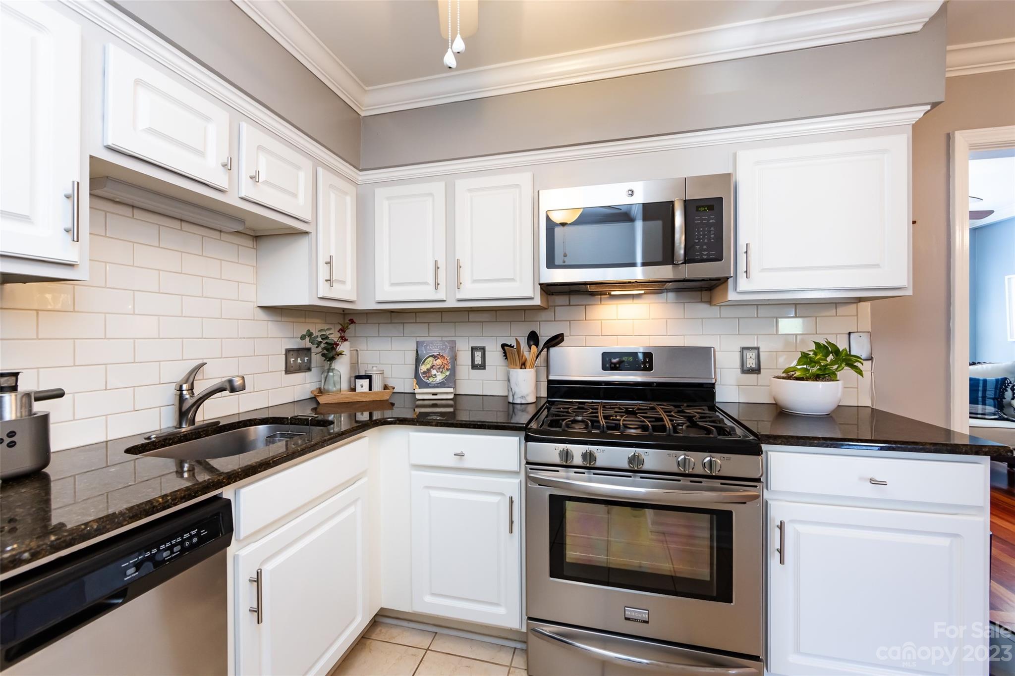 3520 Colony Road, Unit C Charlotte, NC 28211 - Photo 9 of 25 a kitchen with stainless steel appliances granite countertop white cabinets a stove a sink and dishwasher