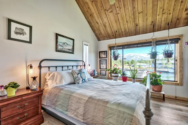 a bedroom with furniture and a large window