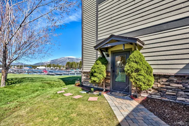 a kitchen with stainless steel appliances wooden cabinets a dining table and chairs