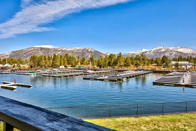 a kitchen with stainless steel appliances granite countertop a refrigerator a sink dishwasher a stove and a microwave oven