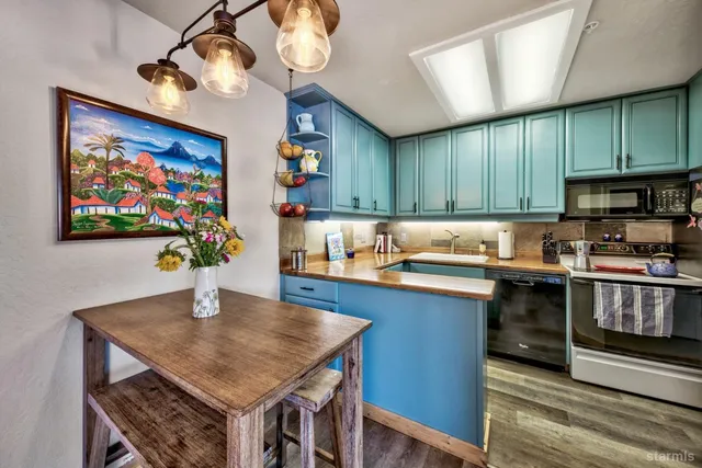 a kitchen with stainless steel appliances granite countertop a sink and cabinets