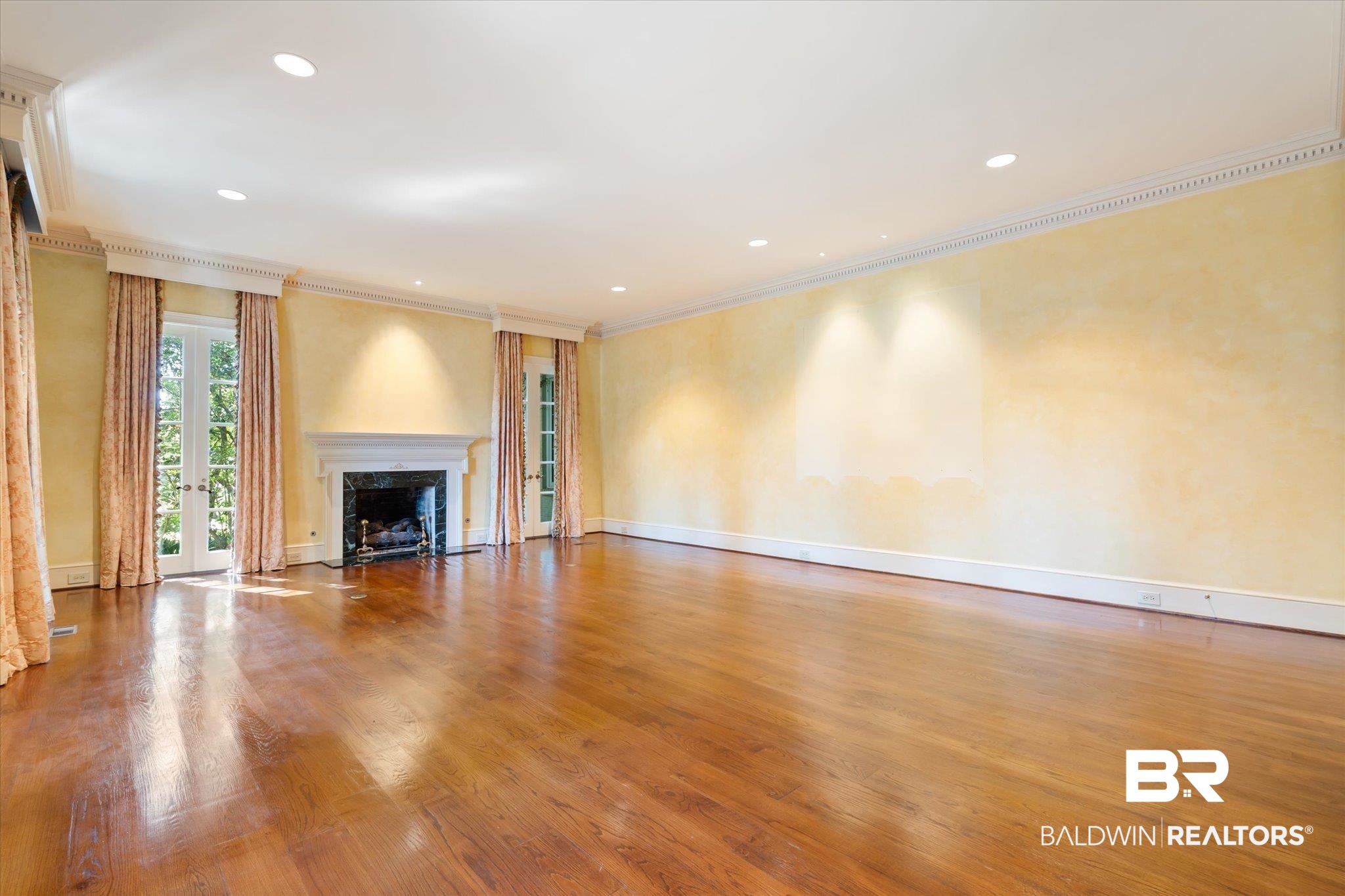 54 Turnin Lane Mobile, AL 36608 - Photo 5 of 35 Unfurnished living room with a high end fireplace, crown molding, and hardwood / wood-style flooring