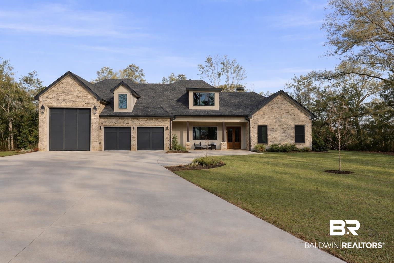 9501 Ben Hamilton Road Theodore, AL 36582 - Photo 1 of 69 View of front of house with a porch, brick siding, a front yard, and an attached garage