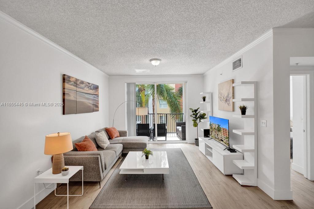 a living room with furniture large window and a table