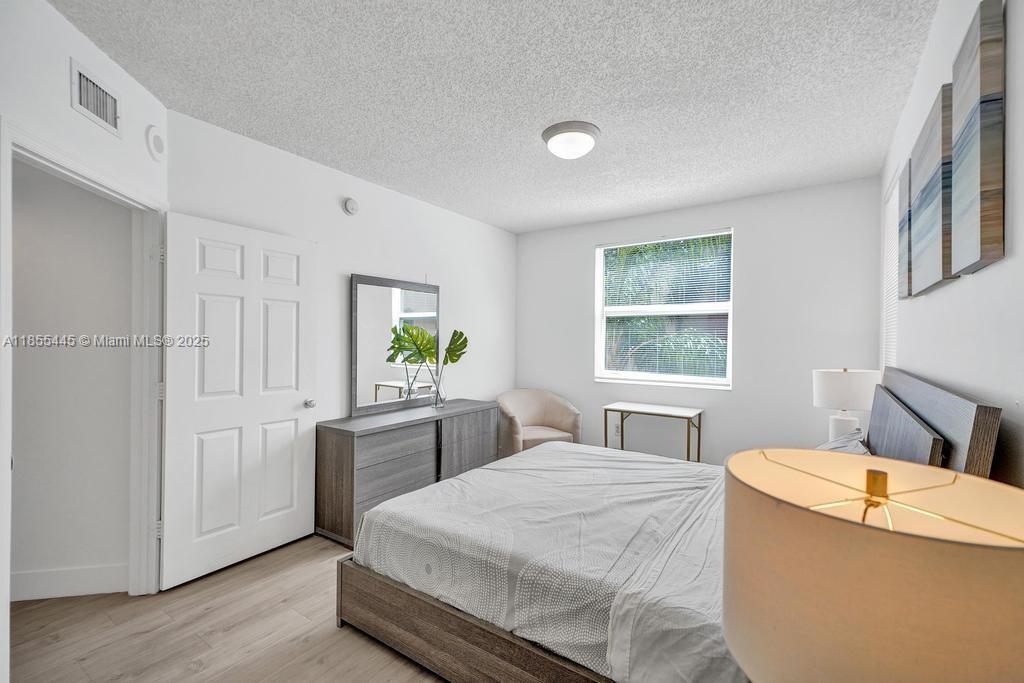 17100 North Bay Road, Unit 1511 Sunny Isles Beach, FL 33160 - Photo 52 of 71 a bedroom with a bed and a table in it