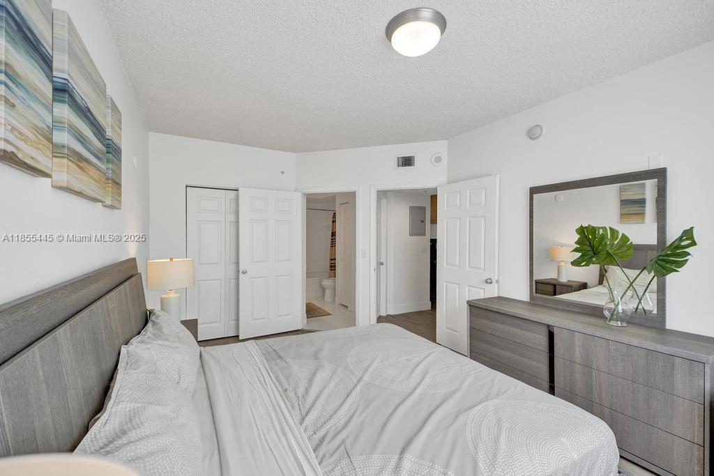 17100 North Bay Road, Unit 1511 Sunny Isles Beach, FL 33160 - Photo 53 of 71 a bedroom with a bed and a potted plant