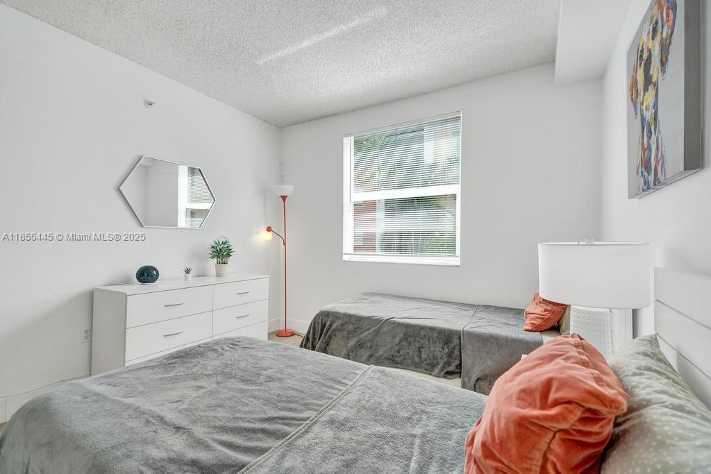 17100 North Bay Road, Unit 1511 Sunny Isles Beach, FL 33160 - Photo 56 of 71 a bedroom with a bed and a window