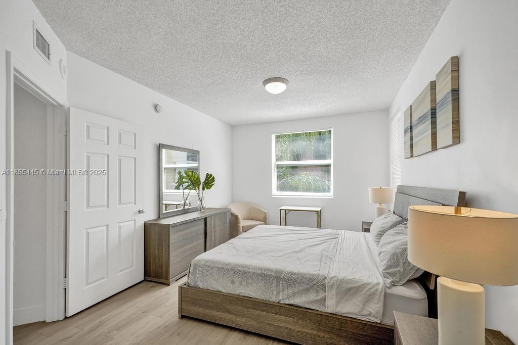17100 North Bay Road, Unit 1511 Sunny Isles Beach, FL 33160 - Photo 6 of 71 a bedroom with a bed and a table in it