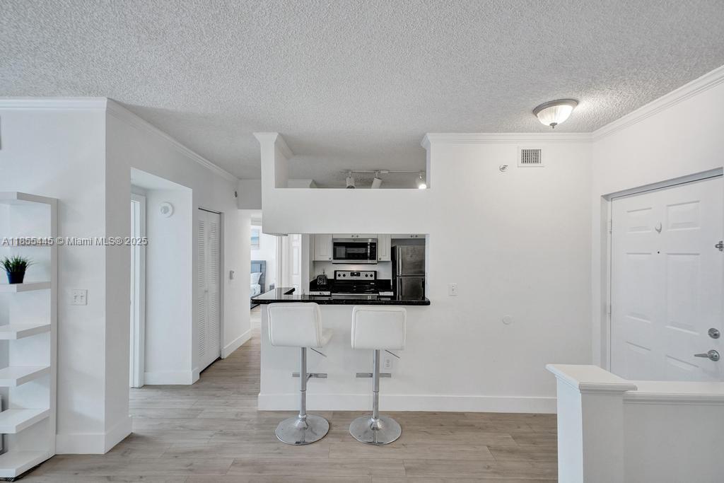 17100 North Bay Road, Unit 1511 Sunny Isles Beach, FL 33160 - Photo 62 of 71 a kitchen with granite countertop a stove and a refrigerator