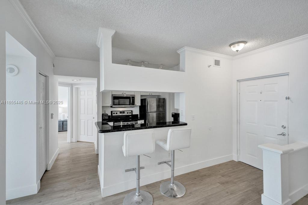 17100 North Bay Road, Unit 1511 Sunny Isles Beach, FL 33160 - Photo 63 of 71 a kitchen with stainless steel appliances a refrigerator and a stove top oven