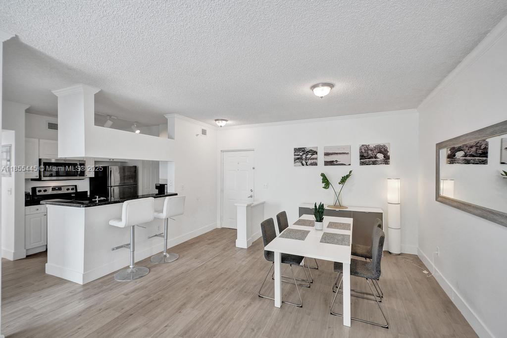 17100 North Bay Road, Unit 1511 Sunny Isles Beach, FL 33160 - Photo 64 of 71 a living room with furniture a dining table and kitchen view