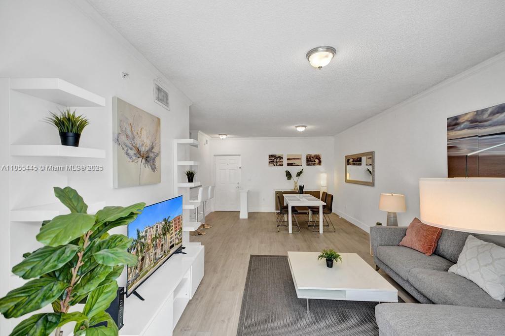 17100 North Bay Road, Unit 1511 Sunny Isles Beach, FL 33160 - Photo 65 of 71 a living room with furniture potted plant and a table