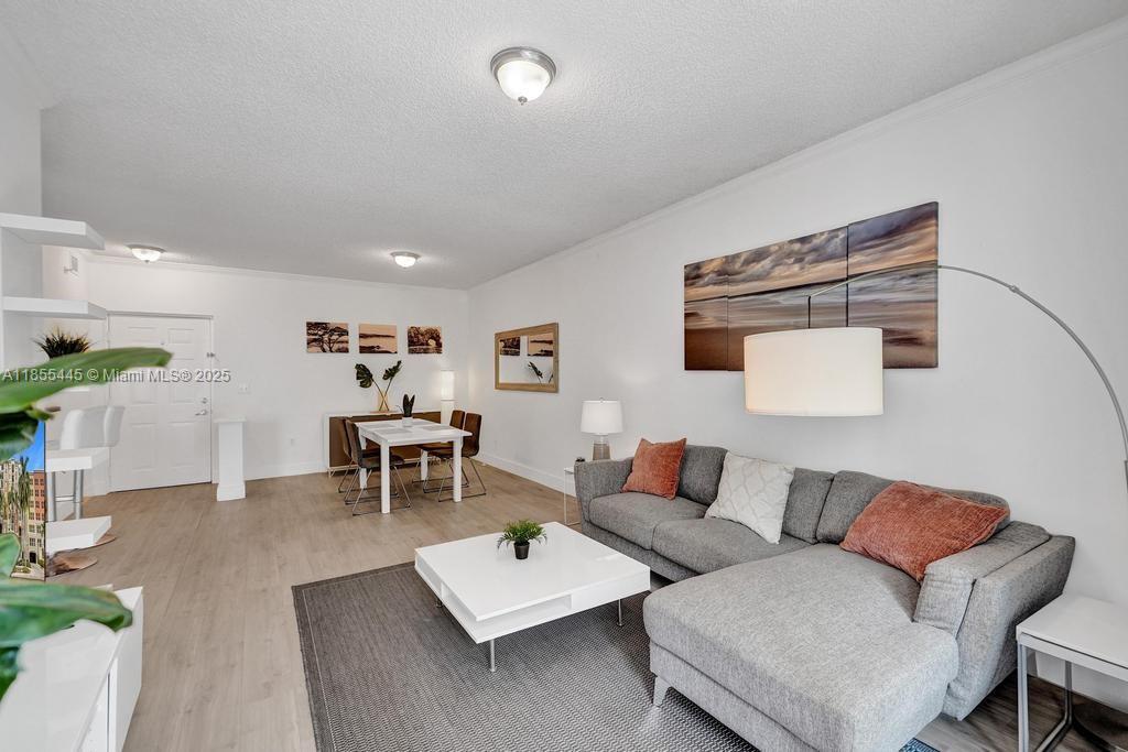 17100 North Bay Road, Unit 1511 Sunny Isles Beach, FL 33160 - Photo 66 of 71 a living room with furniture and wooden floor