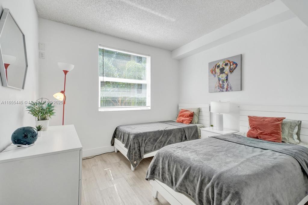 17100 North Bay Road, Unit 1511 Sunny Isles Beach, FL 33160 - Photo 7 of 71 a bedroom with two beds and a potted plant