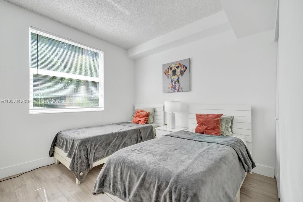 17100 North Bay Road, Unit 1511 Sunny Isles Beach, FL 33160 - Photo 8 of 71 a bedroom with two beds and a window