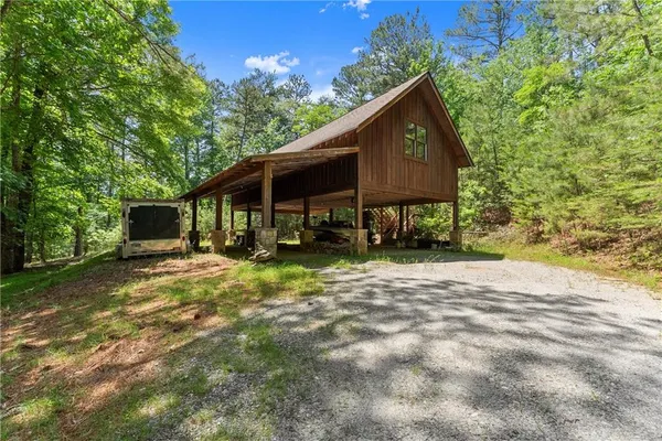 a view of a house with backyard and sitting area