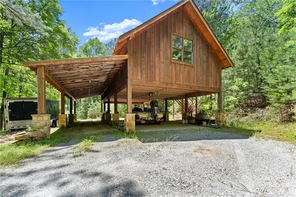a view of a house with backyard and sitting area