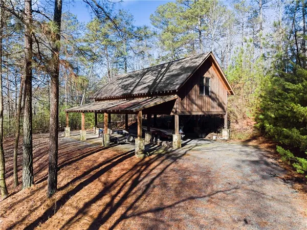 a view of a house with backyard and sitting area