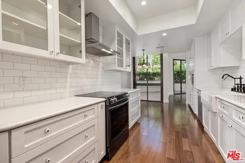 a kitchen with granite countertop a stove and a sink
