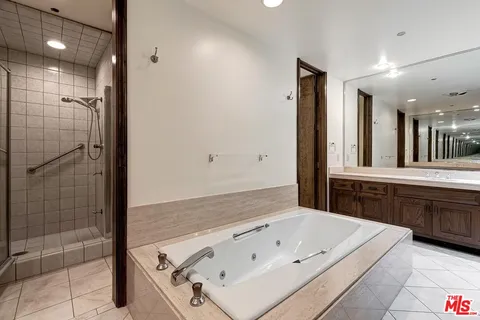 a bathroom with a bathtub and a shower