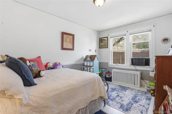 a living room with a bed furniture and a window