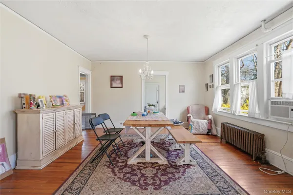 a living room with fireplace furniture and a wooden floor
