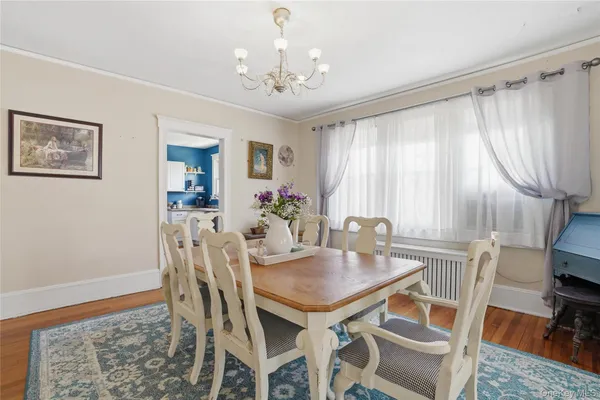 a view of a dining room with furniture and chandelier