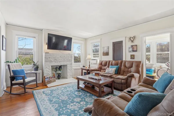 a living room with furniture a rug and a fireplace