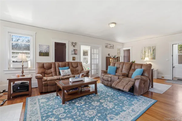 a living room with furniture and wooden floor
