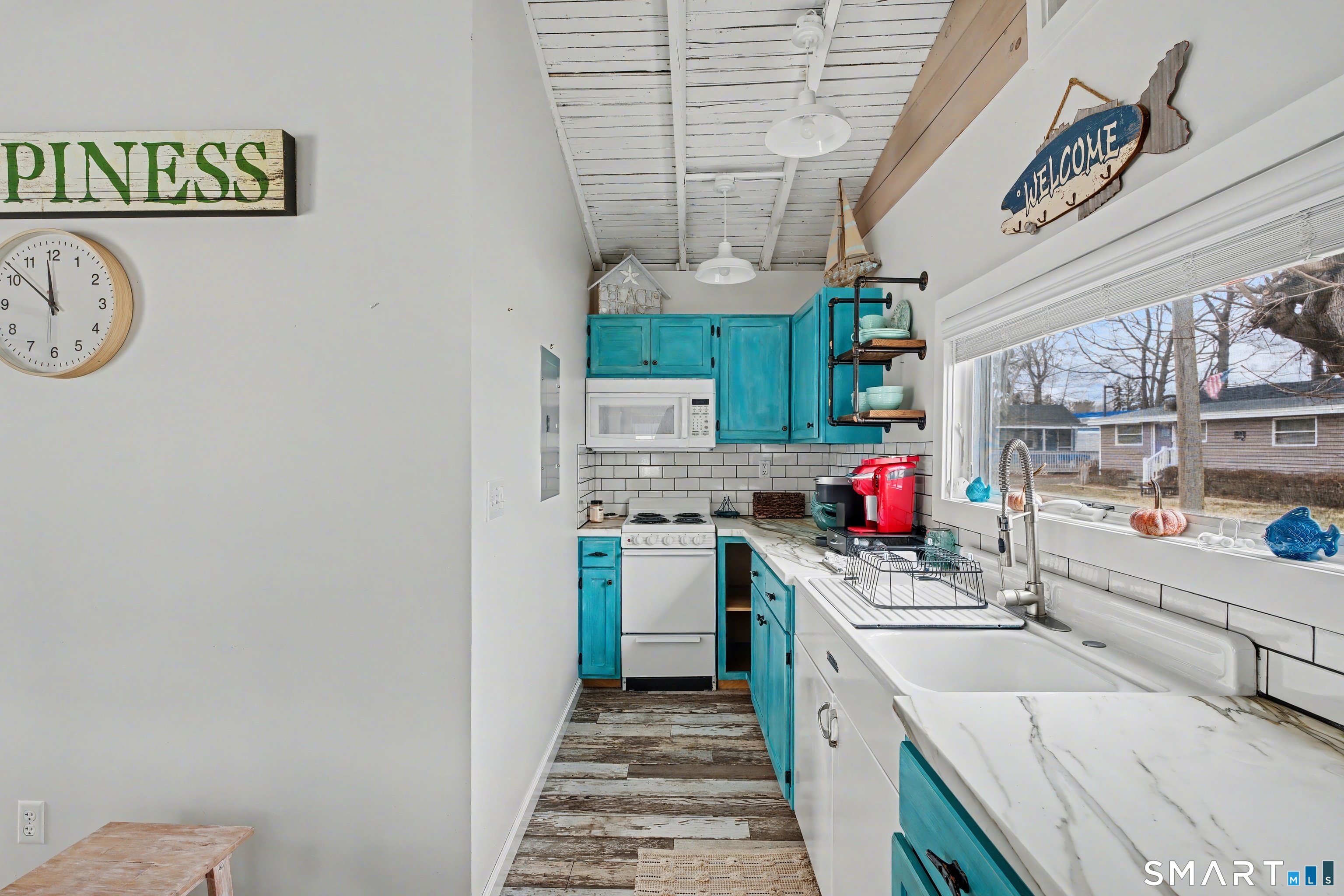 26 North Street Madison, CT 06443 - Photo 15 of 33 a kitchen that has a sink and a stove