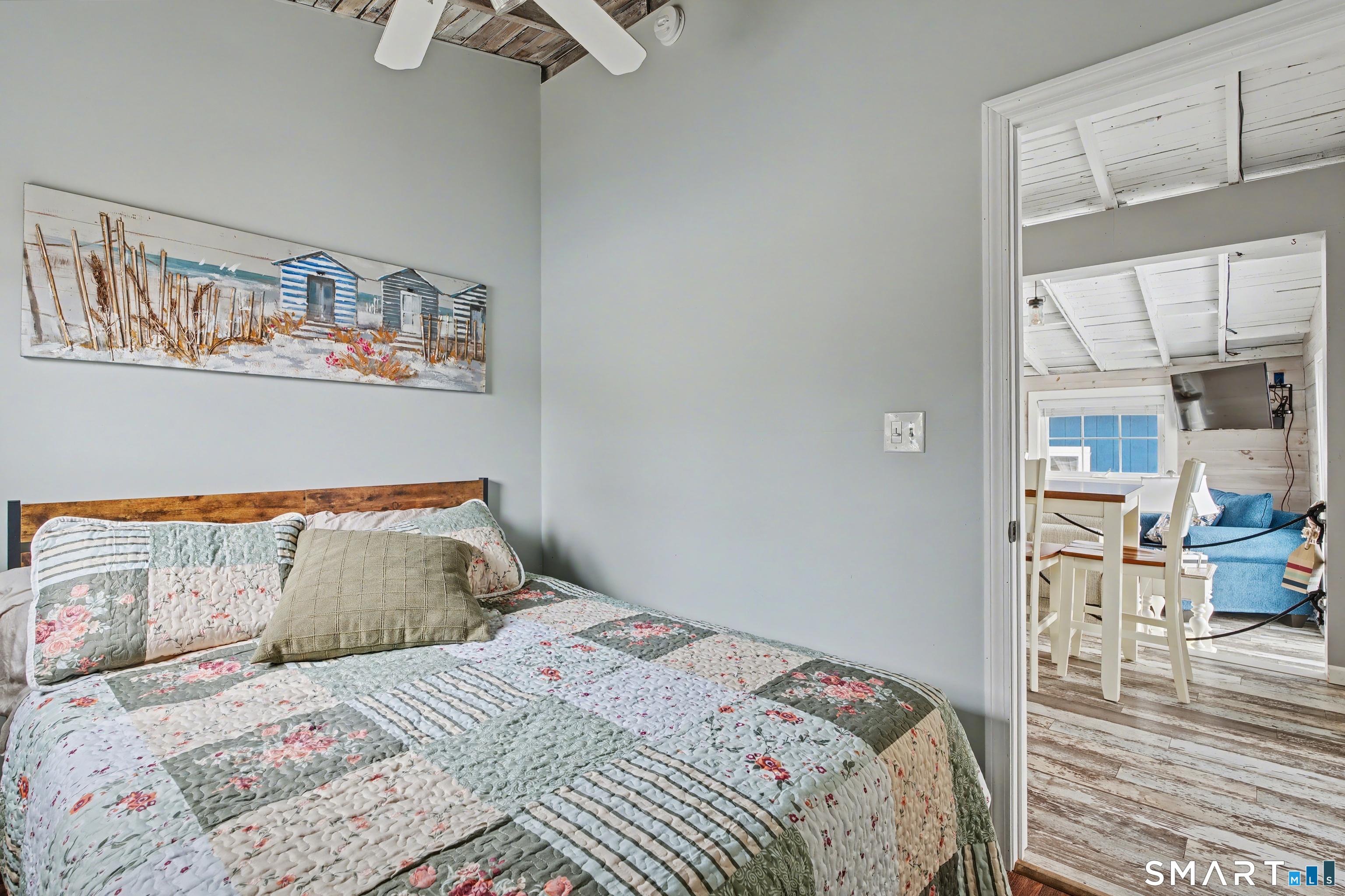 26 North Street Madison, CT 06443 - Photo 20 of 33 a bedroom with a bed and painting on the wall