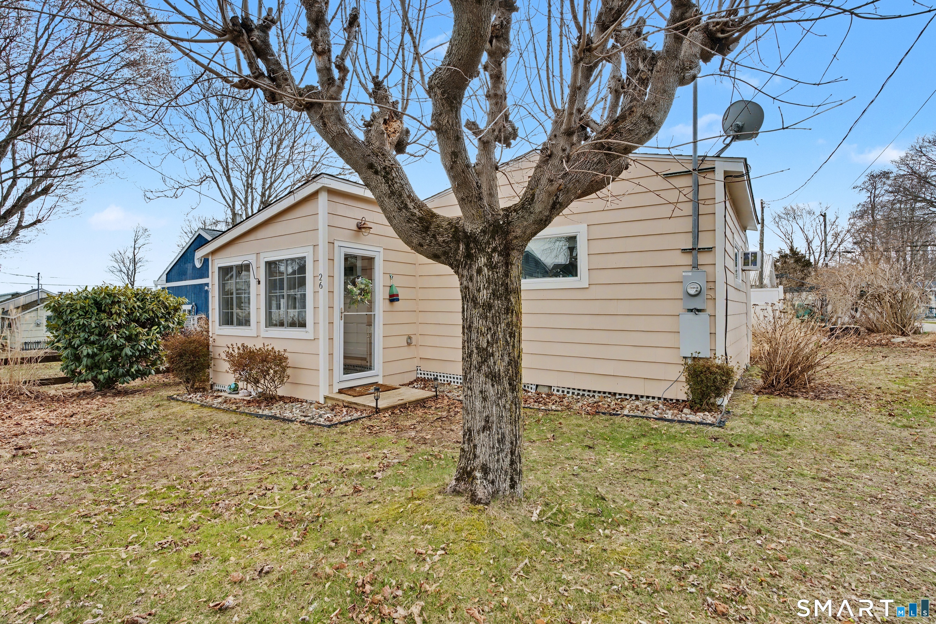 26 North Street Madison, CT 06443 - Photo 2 of 33 a white house that has a tree in front of it