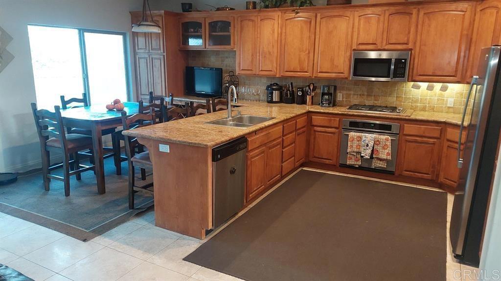 2399 Paige Circle Fallbrook, CA 92028 - Photo 11 of 18 a kitchen with a sink stove and microwave