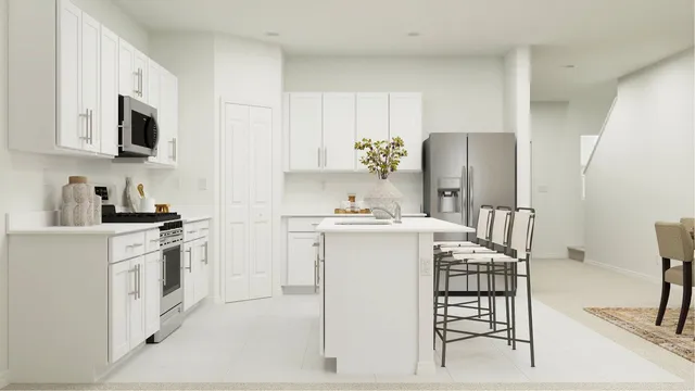 a kitchen with stainless steel appliances a white refrigerator a stove a microwave oven and a dining table with wooden floor