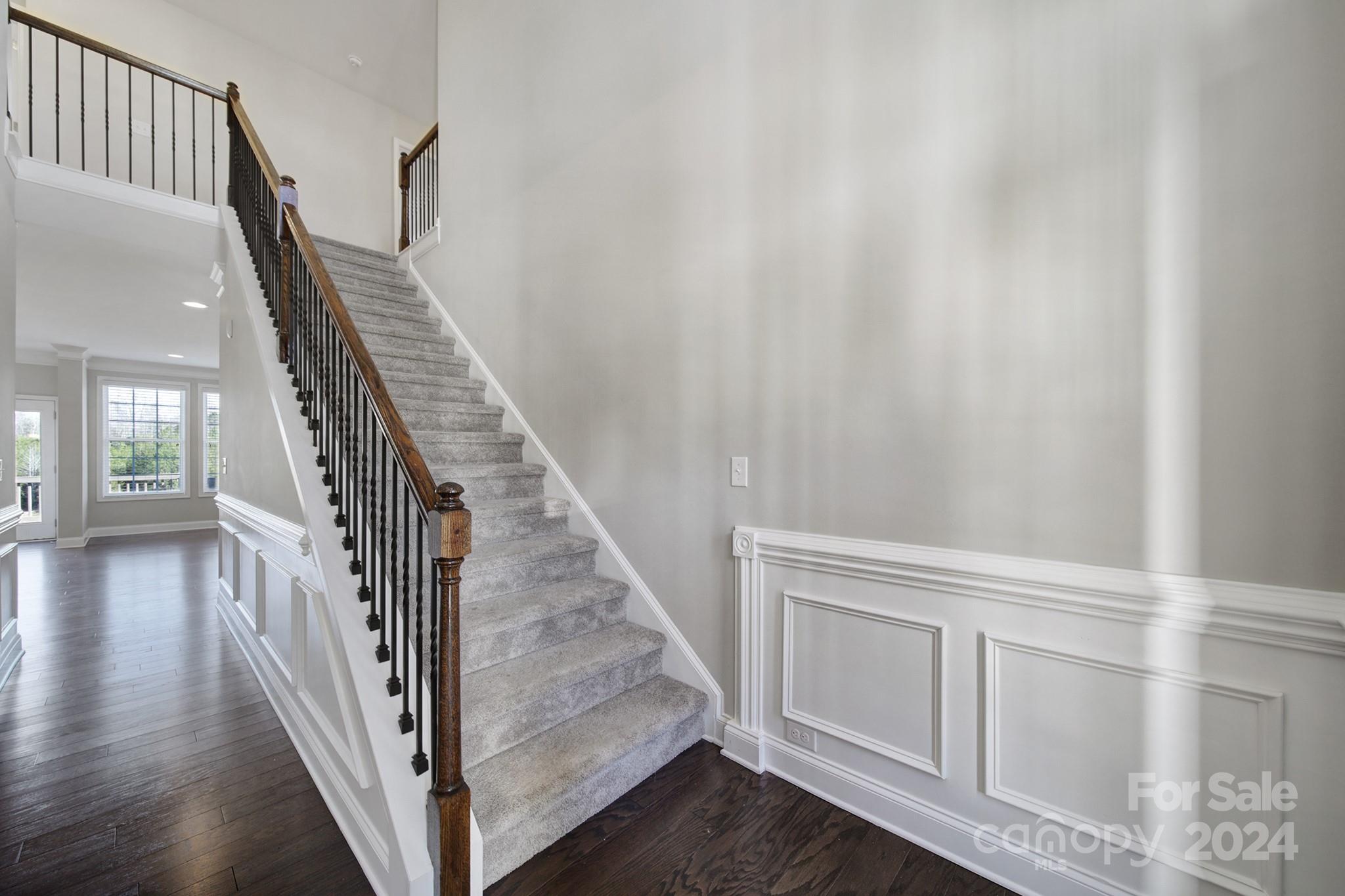 9518 Inverness Bay Road Charlotte, NC 28278 - Photo 3 of 42 a view of a hallway with wooden floor and staircase