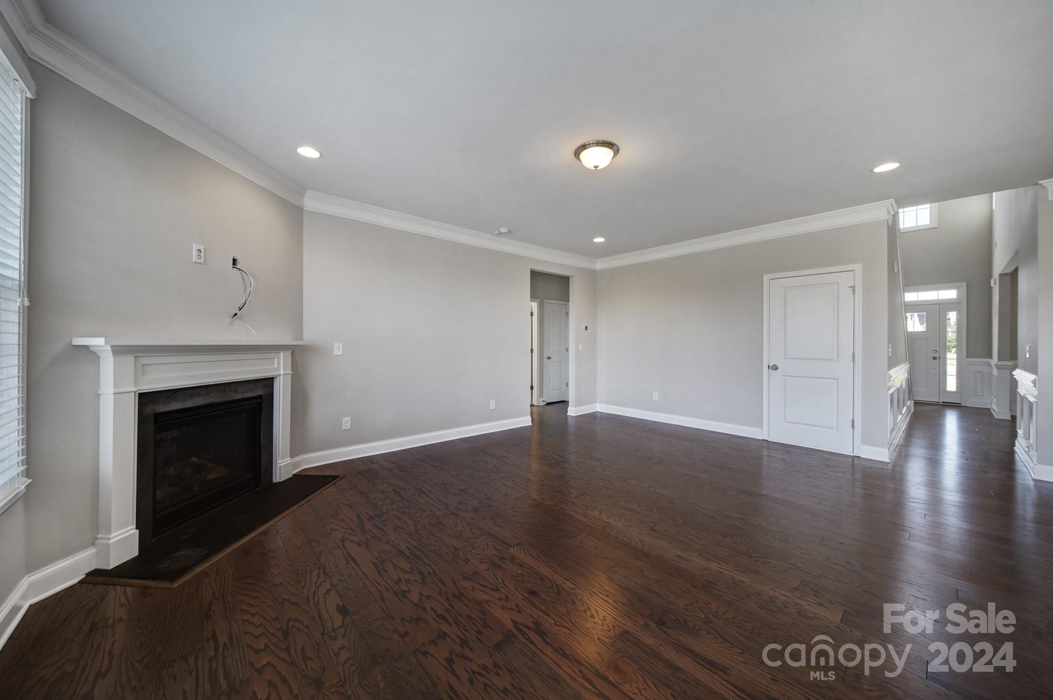 9518 Inverness Bay Road Charlotte, NC 28278 - Photo 7 of 42 a view of an empty room with wooden floor and a fireplace