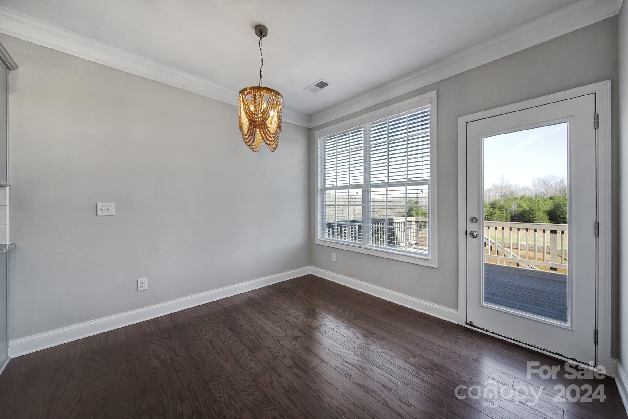 9518 Inverness Bay Road Charlotte, NC 28278 - Photo 9 of 42 a view of an empty room with wooden floor and a window