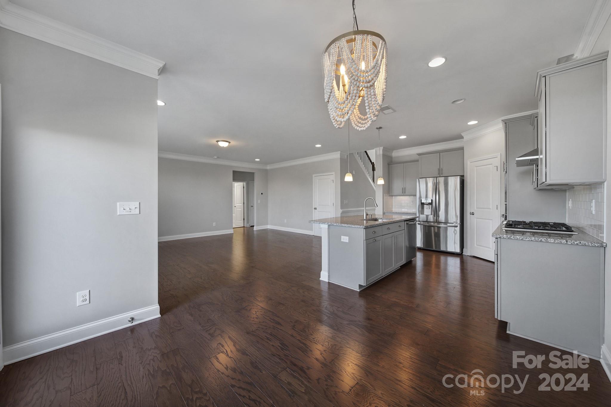 9518 Inverness Bay Road Charlotte, NC 28278 - Photo 10 of 42 a large kitchen with stainless steel appliances granite countertop a large counter top and stove top oven with wooden floor